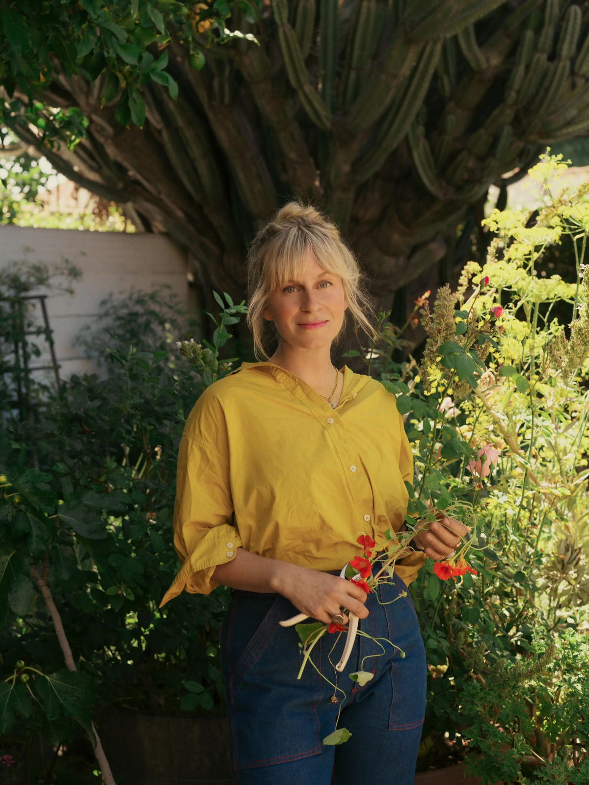 Lily Stockman, artist, in her garden. Photographed by Chantal Anderson. Courtesy of Charles Moffett.