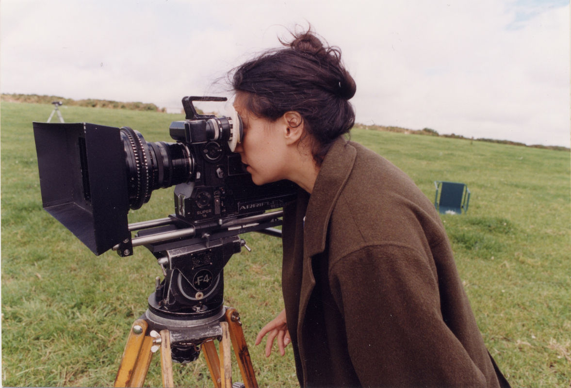 person looking through mounted video camera in a field
