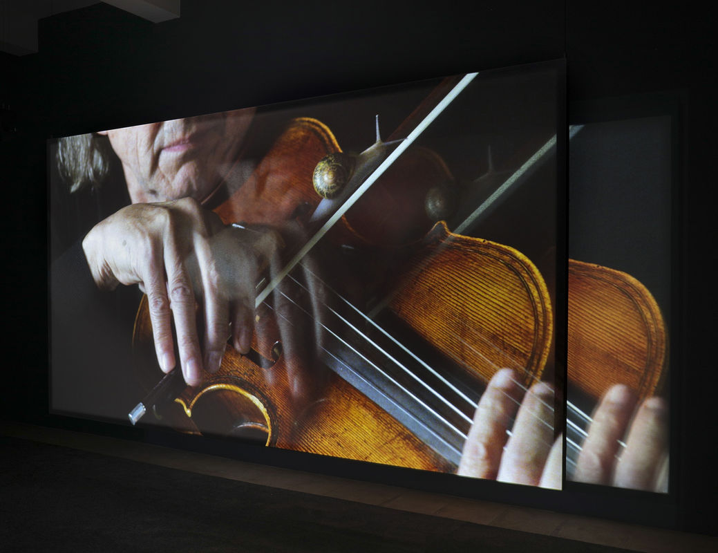 video still of person playing violin