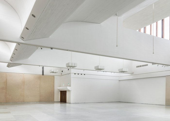 A large and empty white room with skylights. 