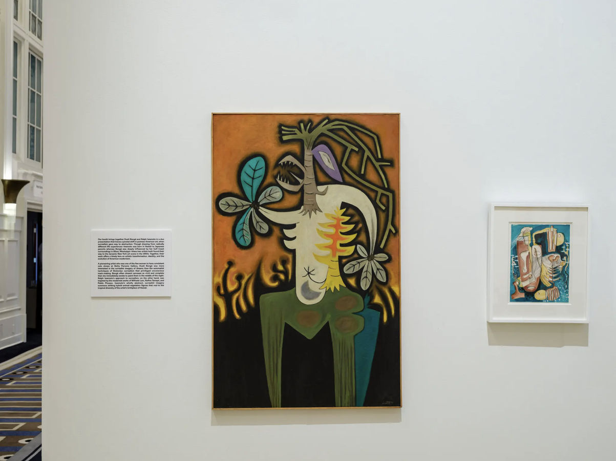 The Hollis Taggart booth includes Ralph Iwamoto’s “Wild Growth” (1955), oil on canvas Taggart),” center. At right is Dusti Bongé’s “Untitled (Surrealist Composition with Mask and Fish Skeleton),” c. 1950. Mixed media on paper.Credit...Karsten Moran for Th