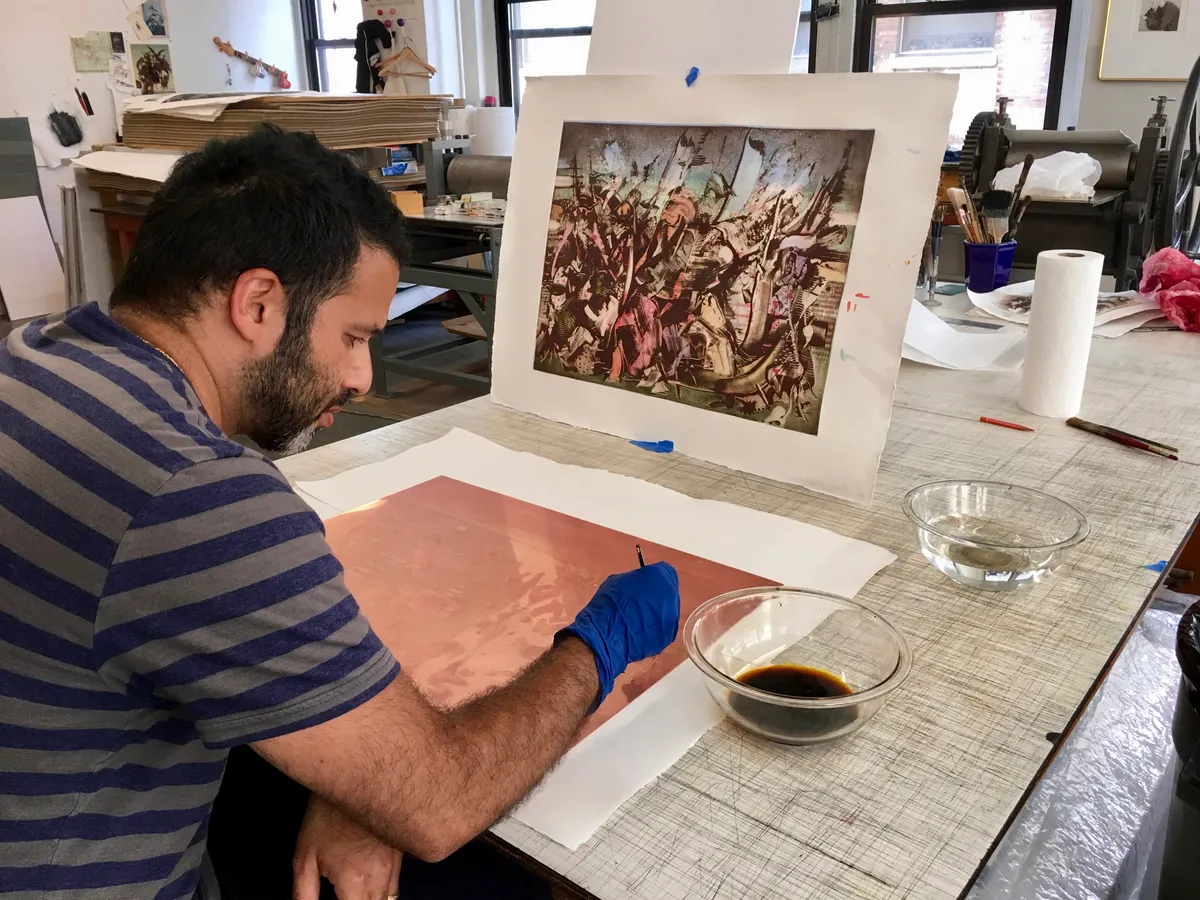 Ali Banisadr working on plates at Burnet Editions, New York, 2019. Photo: Greg Burnet.