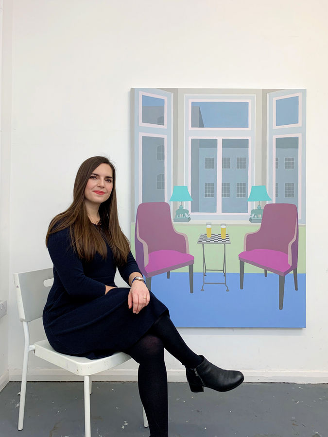 Zsofia Schweger pictured in her studio with her painting, At the Pub (Fitzroy Tavern in Fitzrovia, London), 2020.