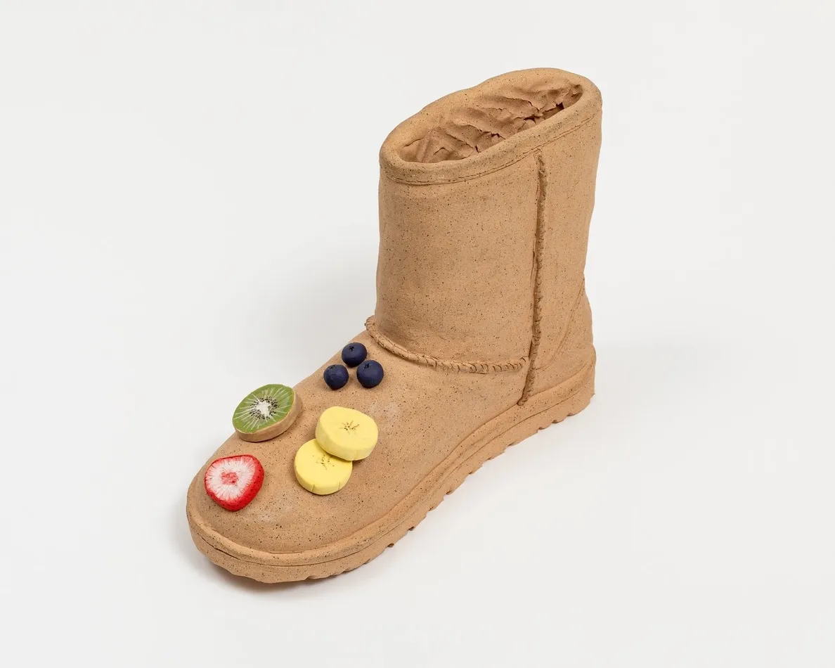 Didi Rojas sculpture of Ugg with fruit on toe