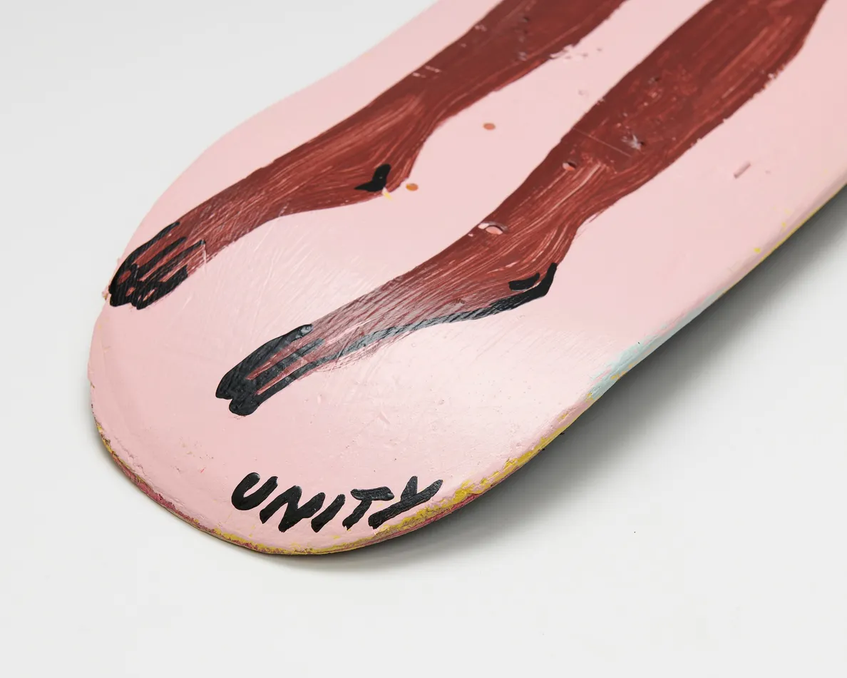 skateboard deck with nude figure on pink background