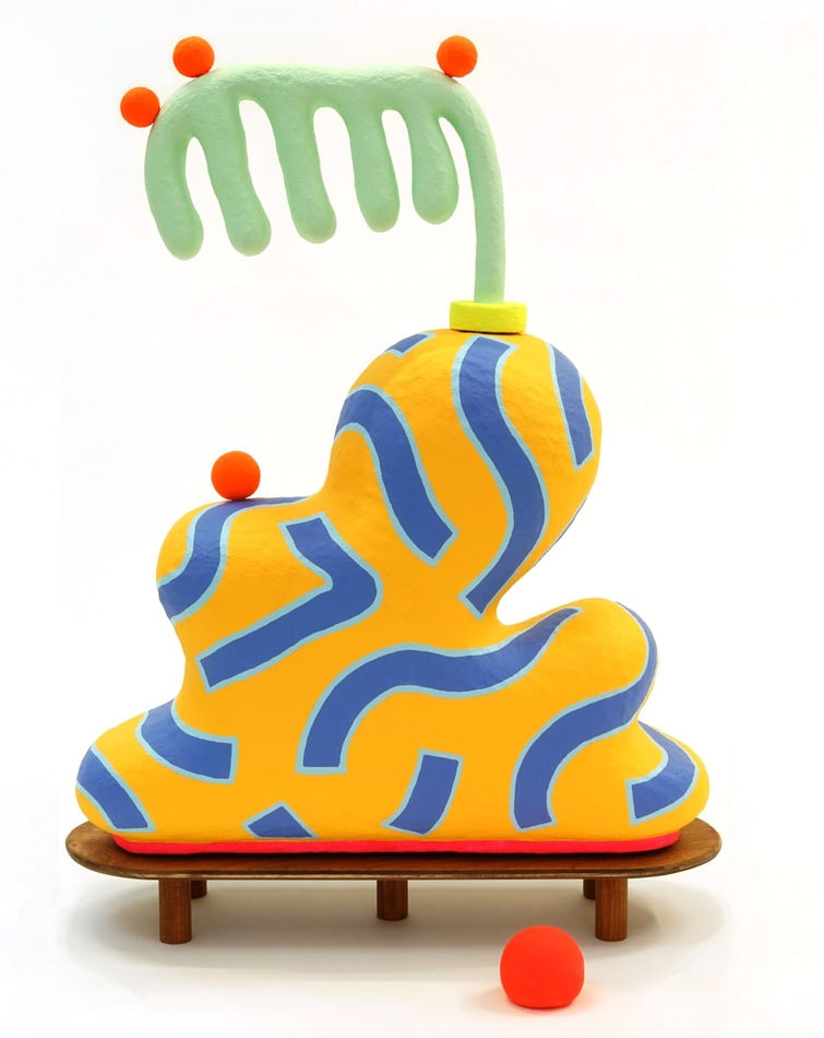 Chiaozza paper pulp sculpture of abstract yellow and blue vase with comb-like green plant on small wooden table base