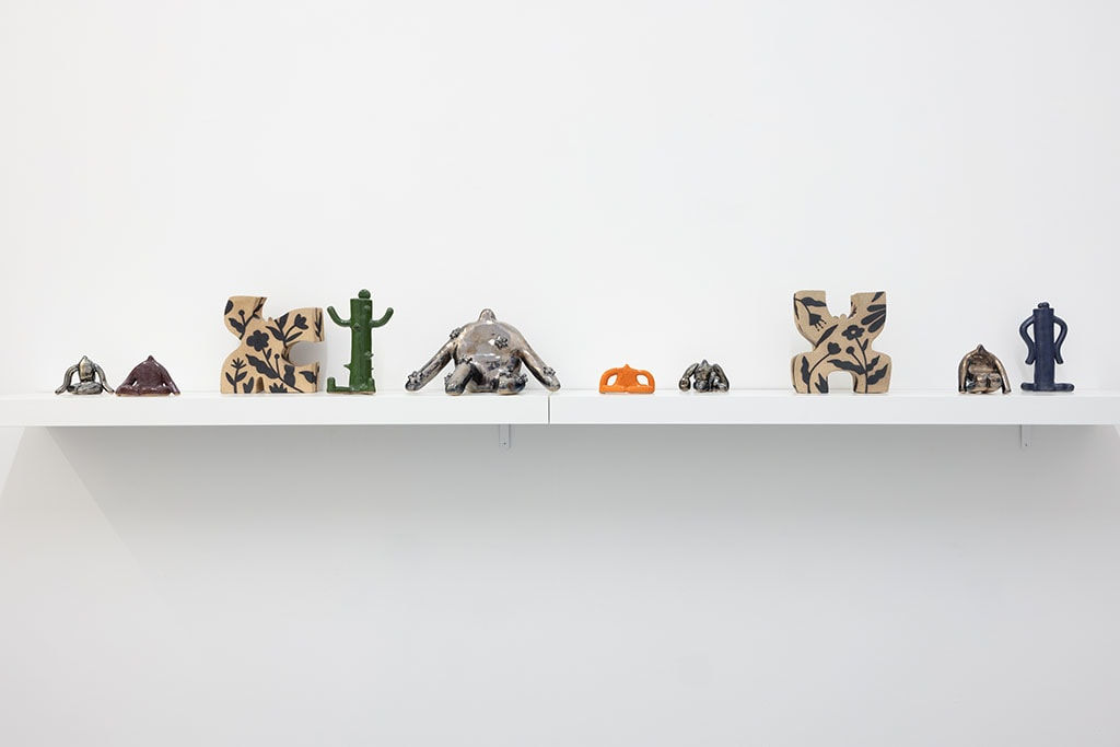 white shelf with assorted small figure statues by Jocelyn Tsaih