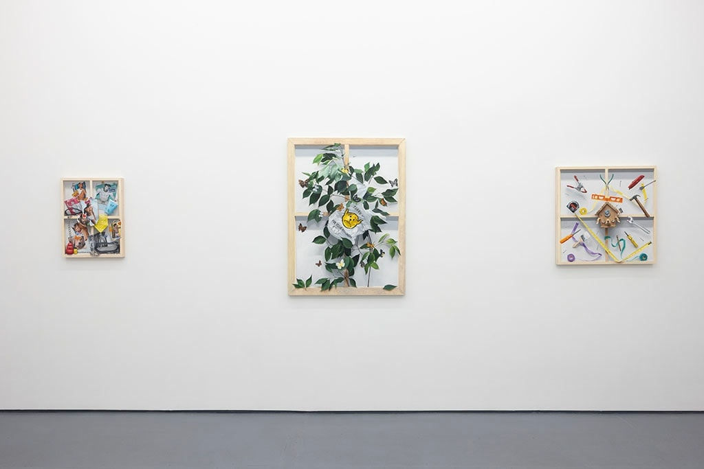 white wall with three paintings displayed