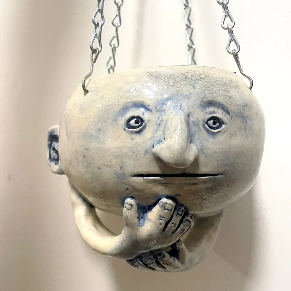 Dave Zakin's hanging sculpture of a face with hands