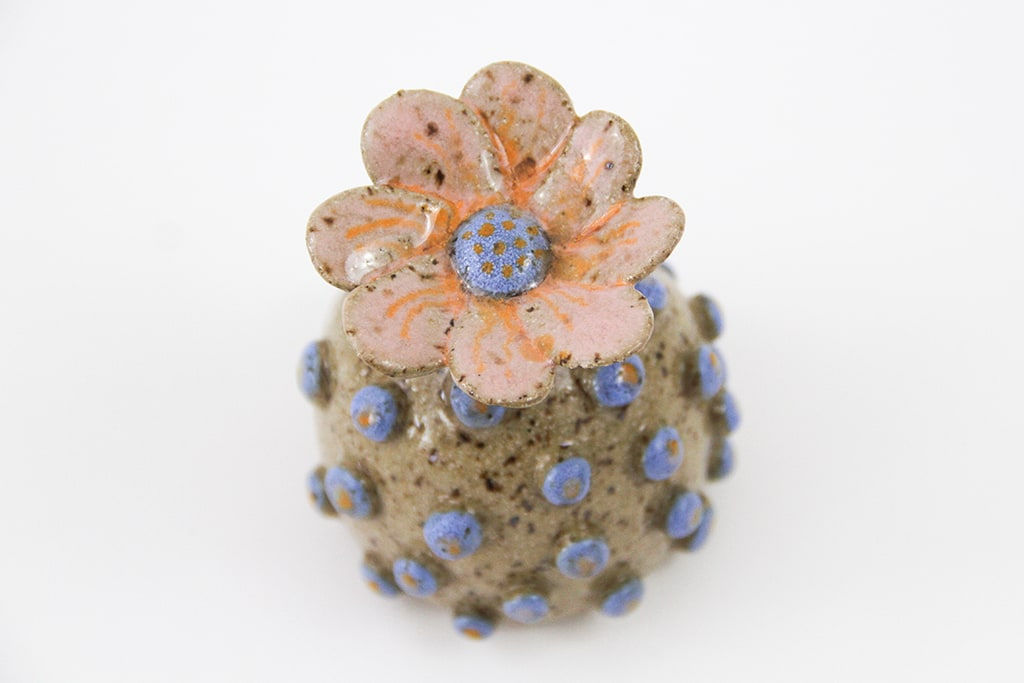 Jen Dwyer sculpture - round tan plant with blue dots all over and pink flower on top