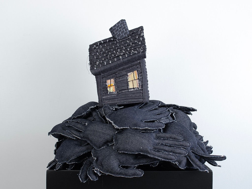 Tania Alvarez sculpture of house on bed of hands