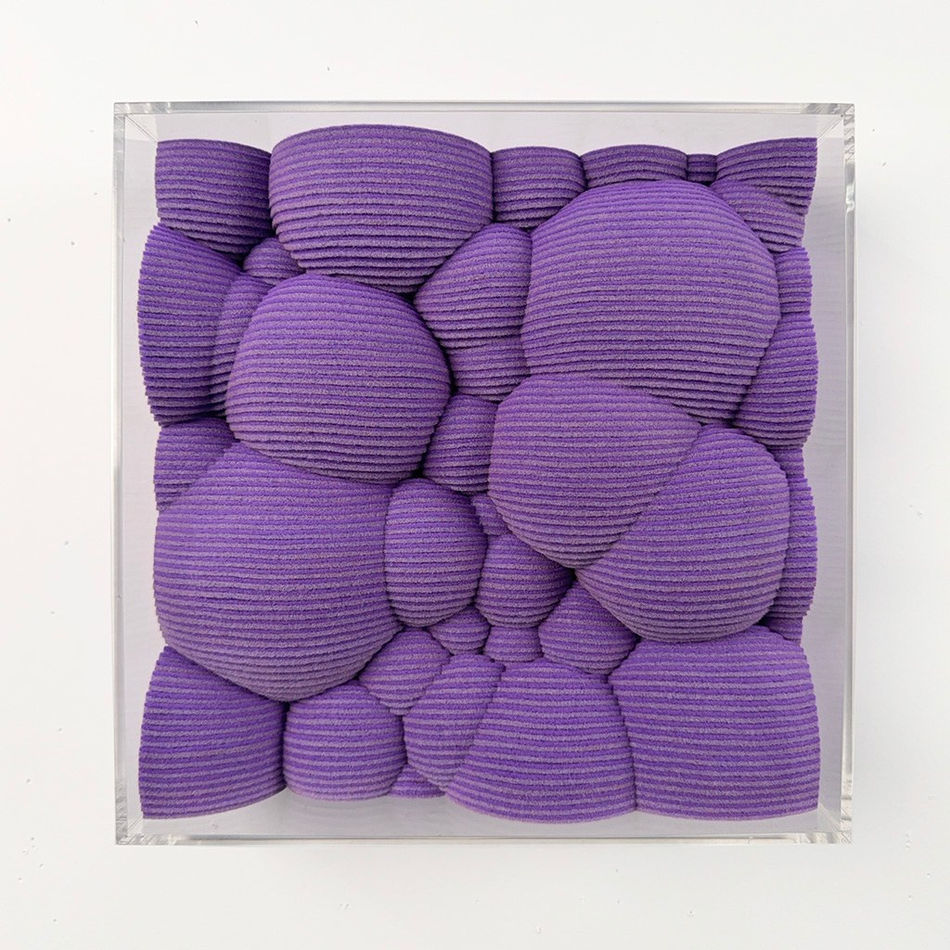 Textured purple square made from felt with a clear acrylic frame