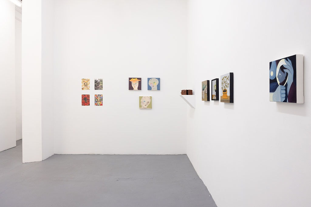 white gallery walls with small artworks