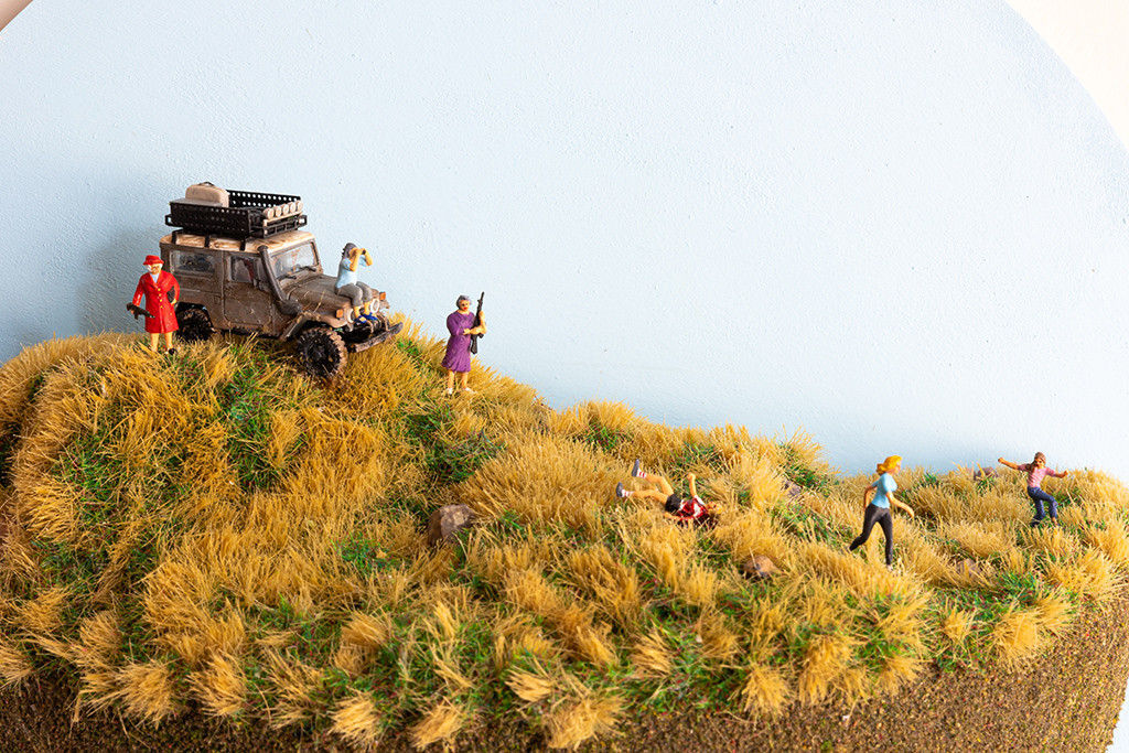 miniature diorama by Abigail Goldman of three elderly woman hunting a group of people running away