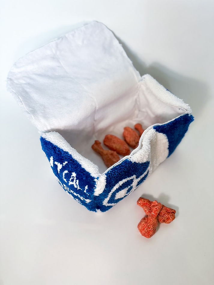 Thomas Martinez Pilnik - a yarn sculpture of a box from Chicken Cottage with a set of 6 glazed terracotta chicken wings