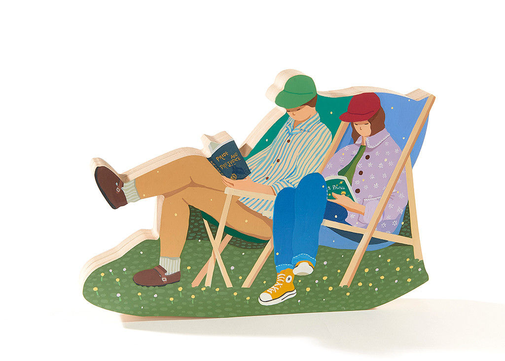 sculpture of two people sitting while reading