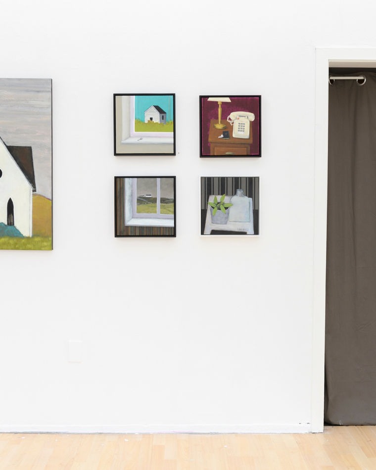 photo of various paintings hung on a white wall