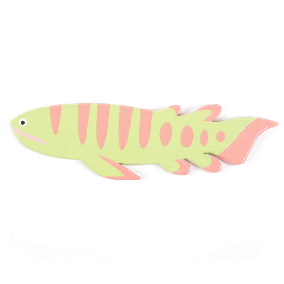 ceramic wall hanging of a pink and green prehistoric fish
