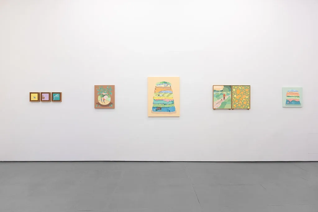 White gallery wall with various paintings by Danym Kwon