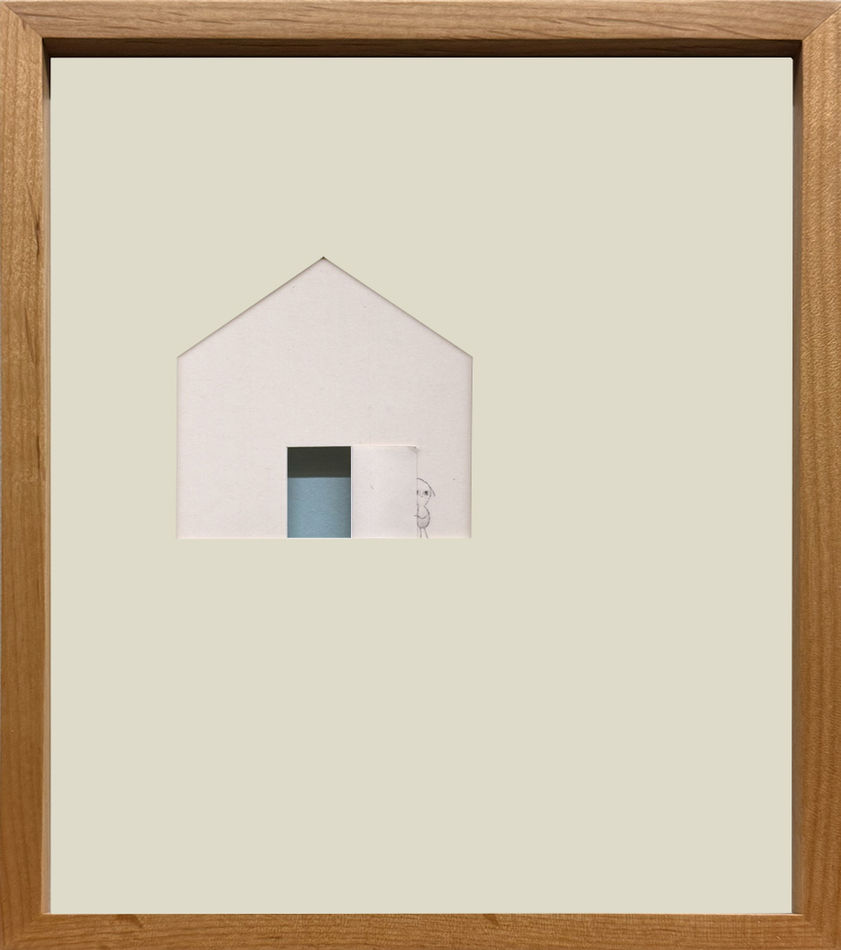 Framed paper cut out of a house with a little creature standing behind an open door