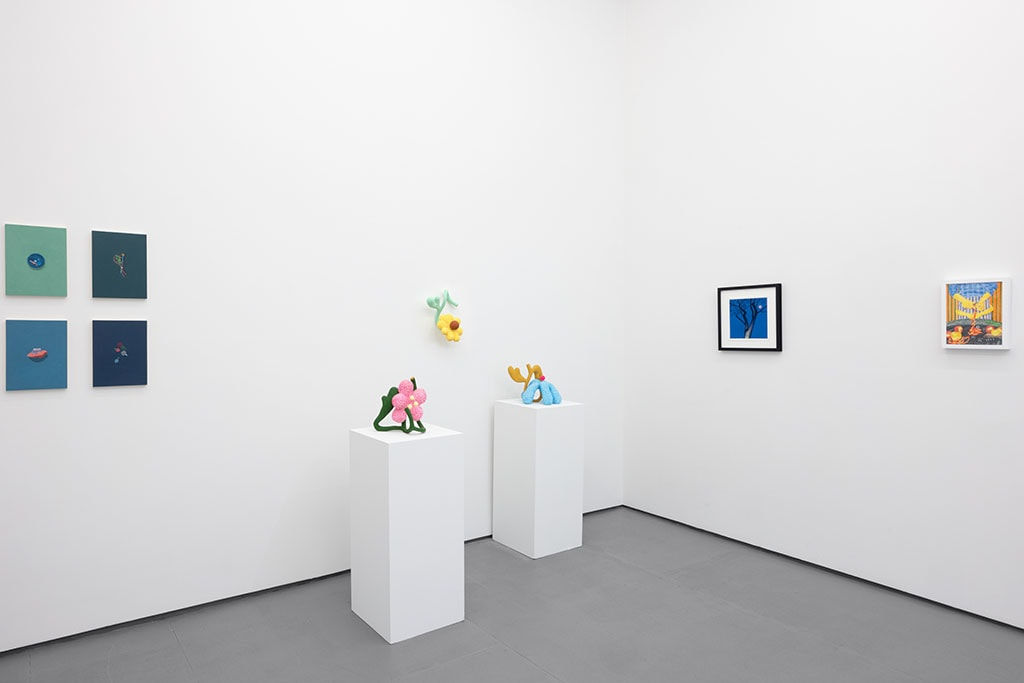 white gallery walls with small artworks and sculptures