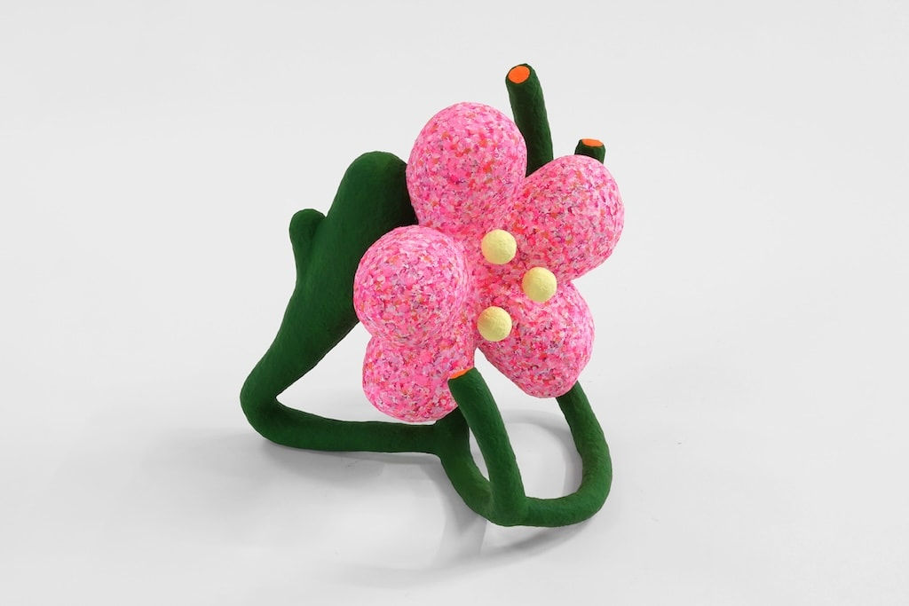 Pink flower sculpture supported by green stems