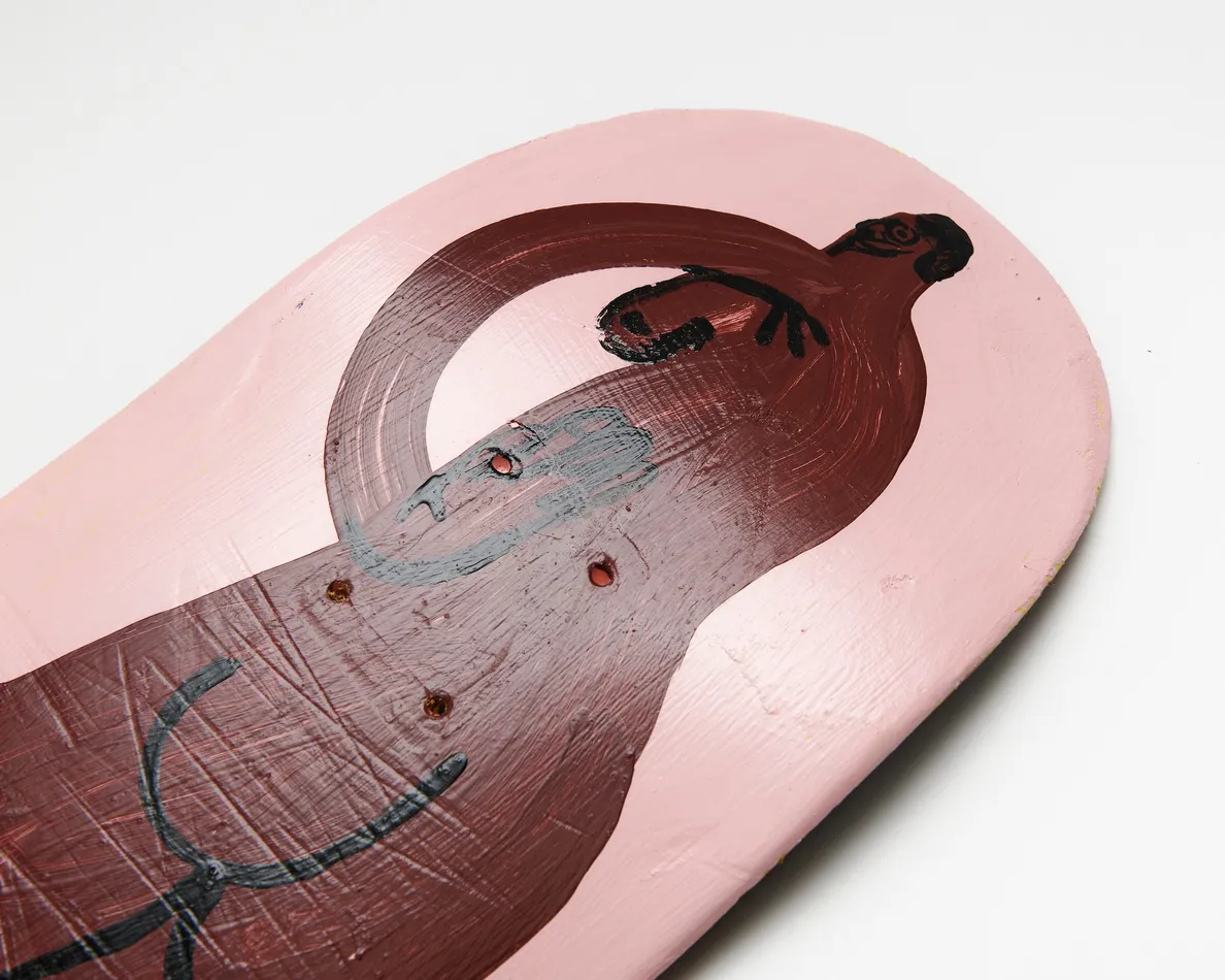 skateboard deck with nude figure on pink background