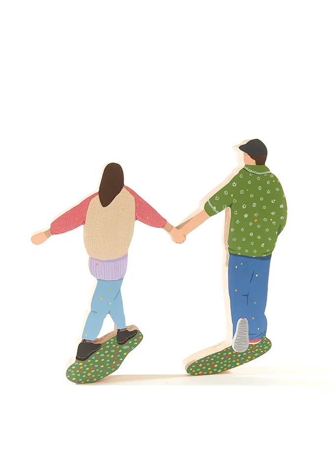 sculpture of two people walking while holding hands