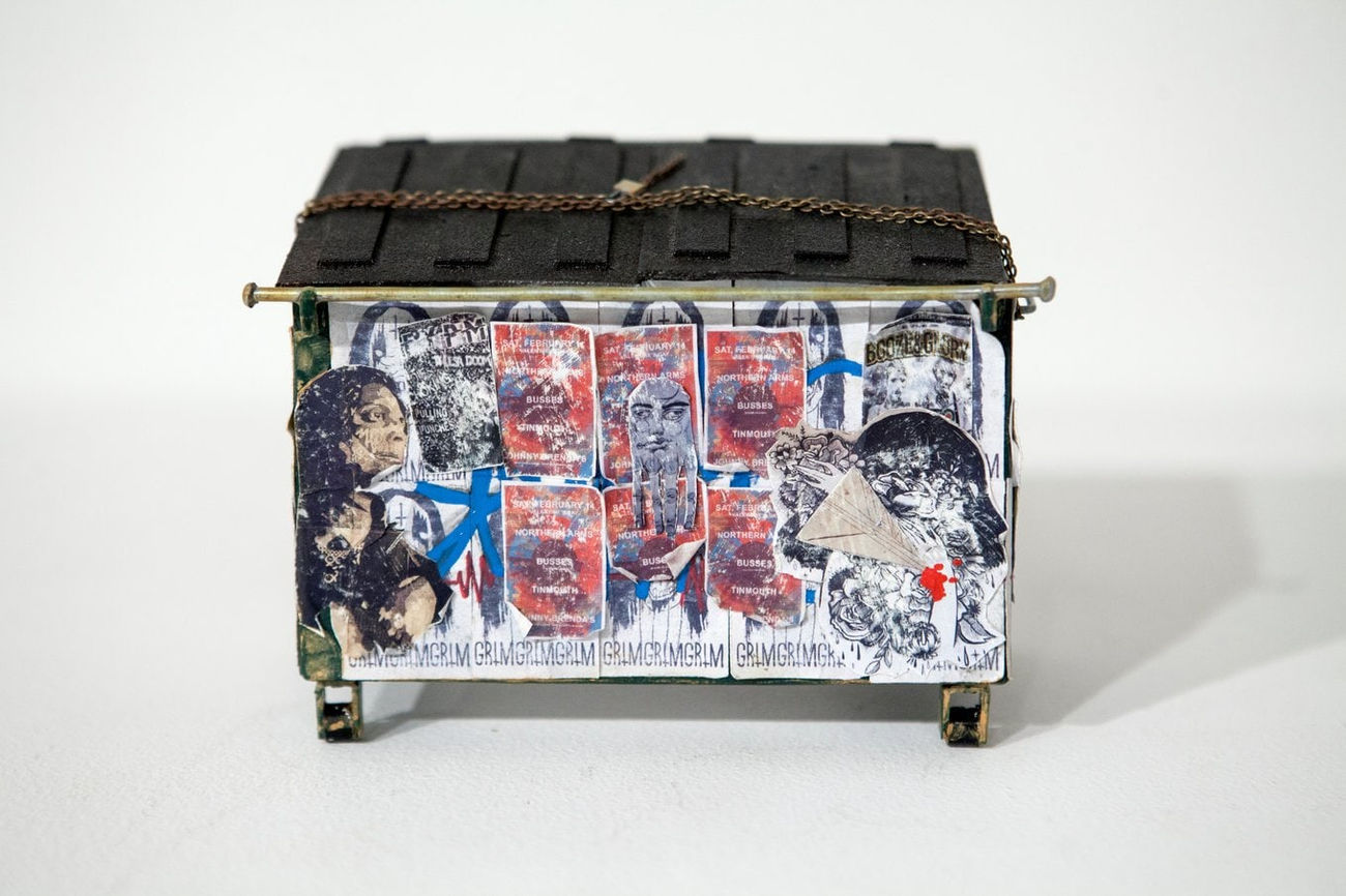 Drew Leshko miniature blue dumpster covered in wheatpaste
