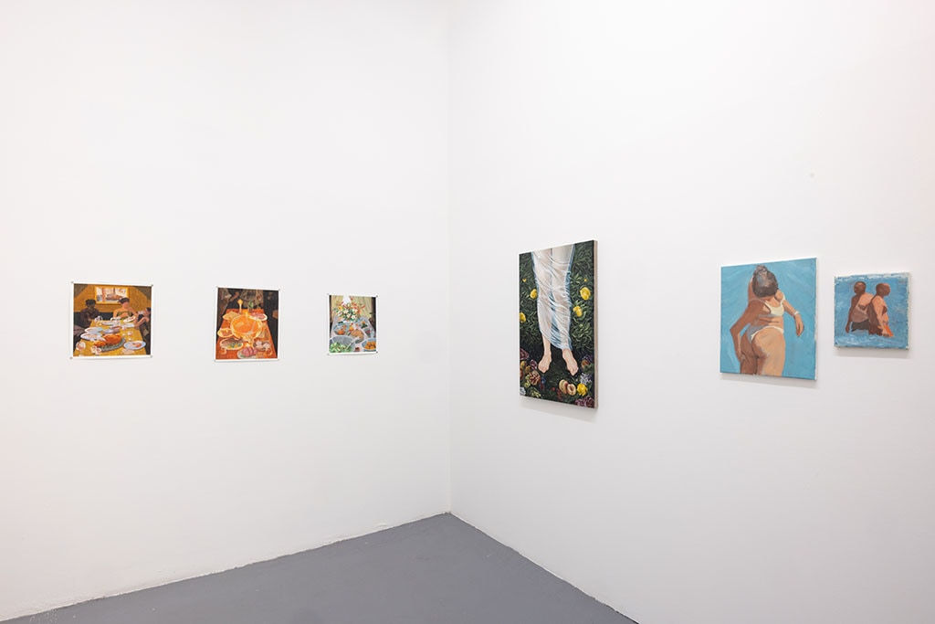 Whtie gallery walls with paintings of various sizes on the wslls