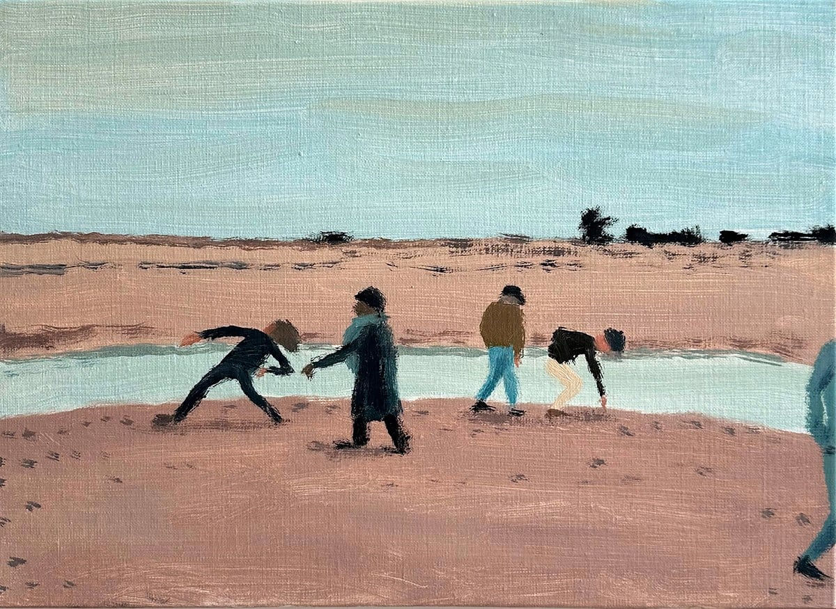 group of people skipping rocks along the beach