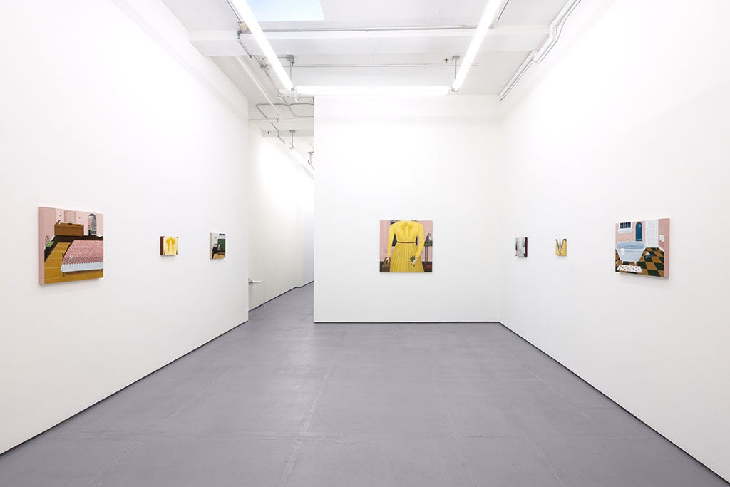 White gallery walls with paintings of various sizes by Angela Burson