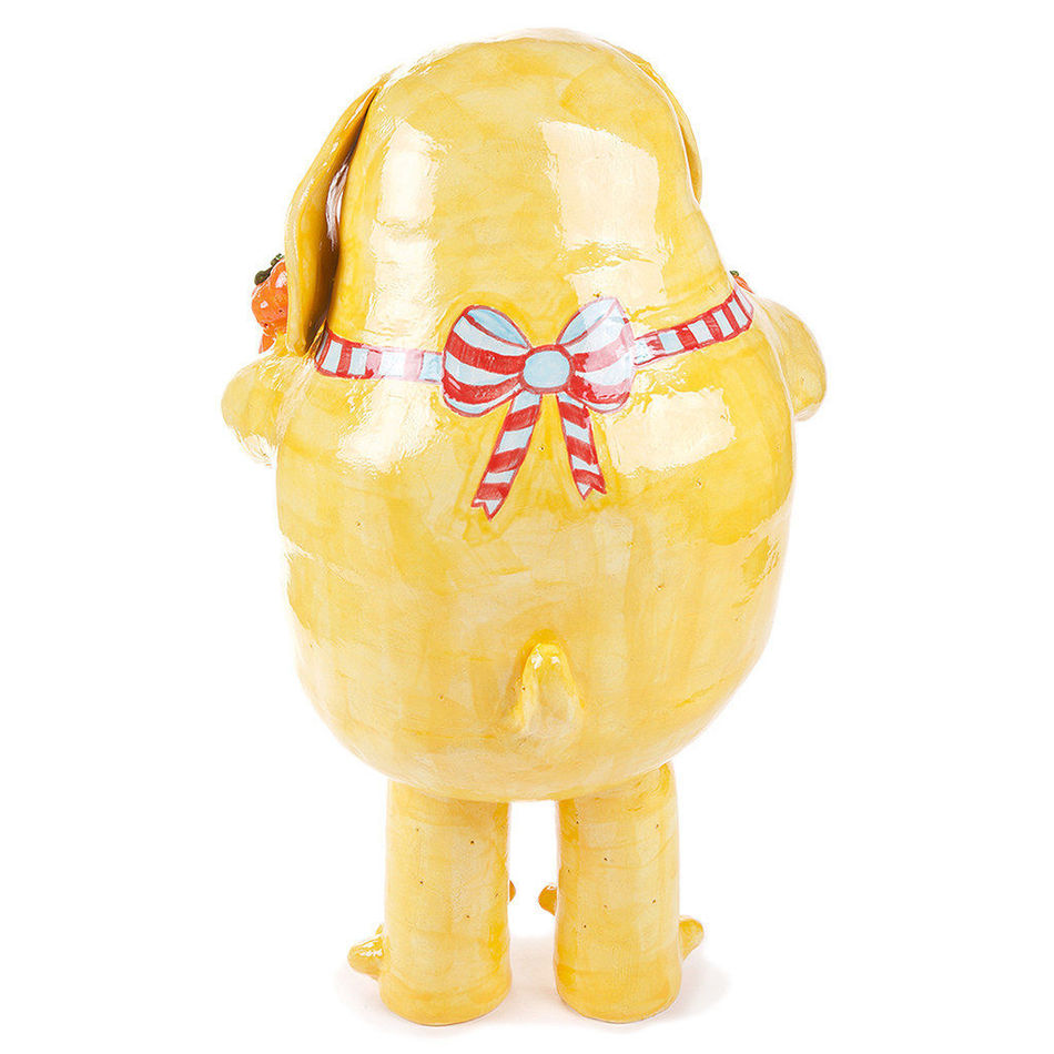 Katie Kimmel's ceramic sculpture of a dog holding fruit in a red checkered apron