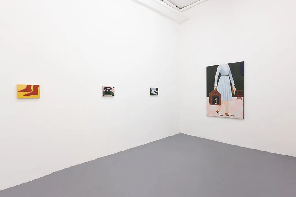 White gallery wall with paintings of various sizes by Angela Burson