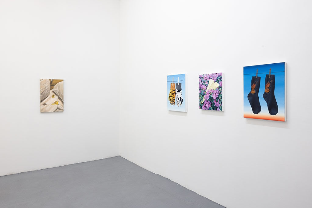 white gallery walls with paintings by Sara Suppan and Cait Porter