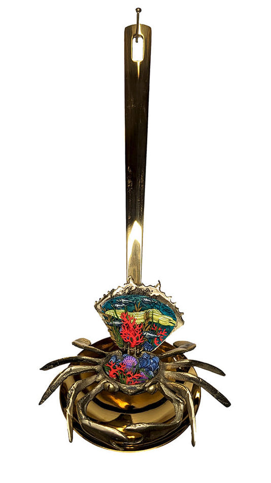 Sculpture of a brass crab with an underwater scene inside of the crab shell
