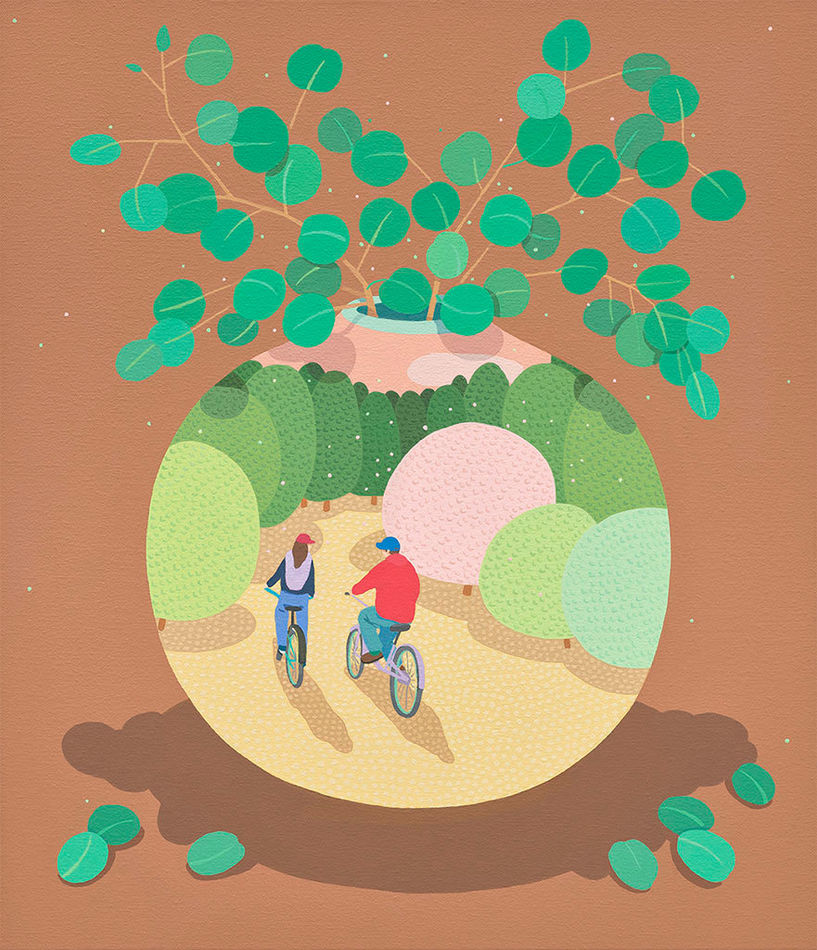 a vase with a plant poking out and a scene of two people riding bikes on it on a brownish orange background