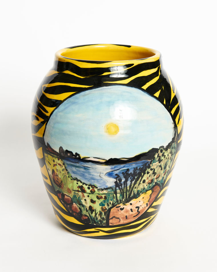 Anna Valdez ceramic vase with yellow and black zebra stripes and painted image of a body of water with sunset