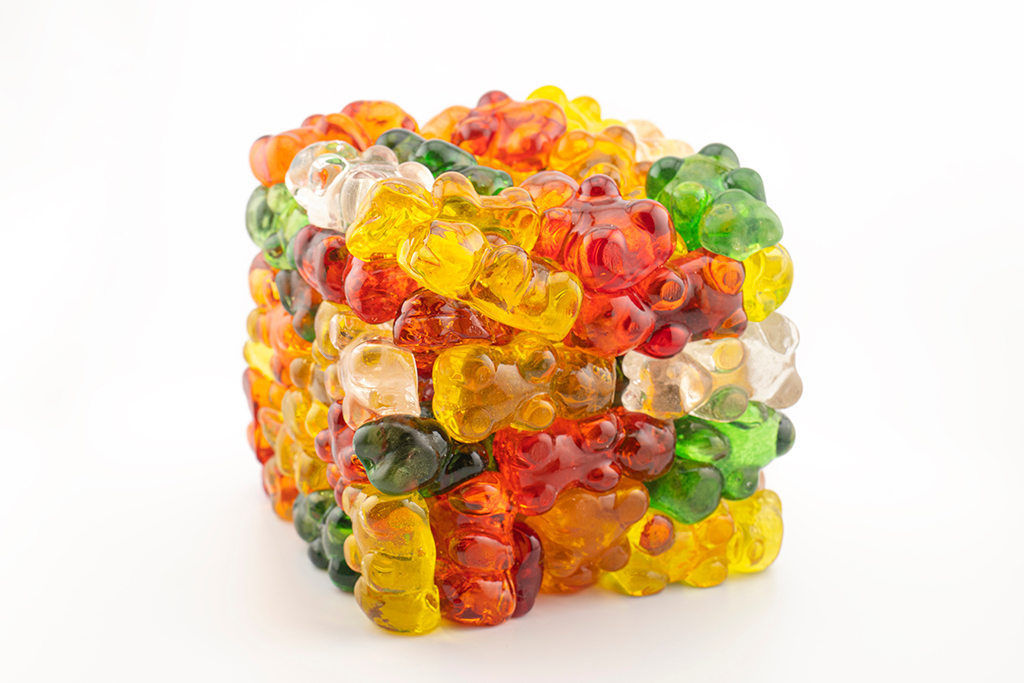 Glass sculpture of gummy bears stacked into a cube