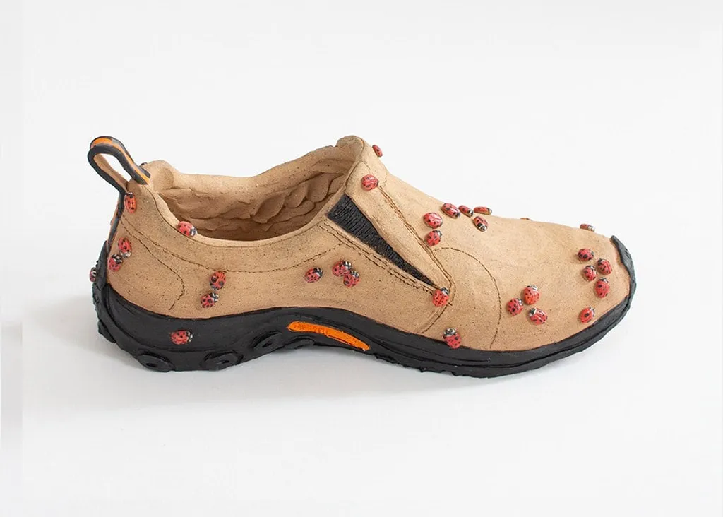 Didi Rojas sculpture of brown shoes covered in ladybugs