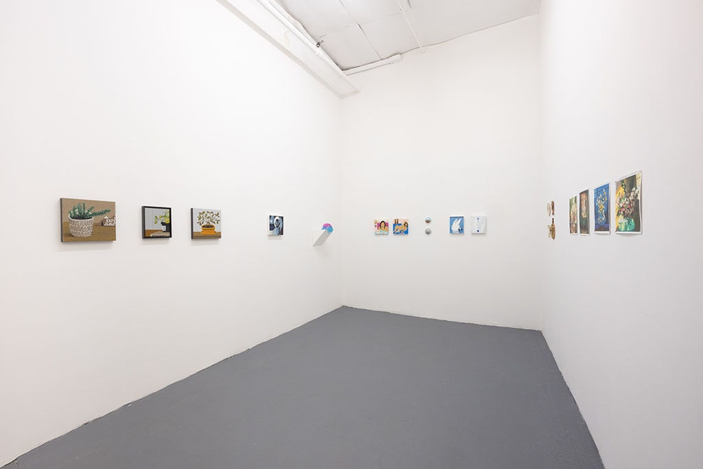 white gallery walls with small assorted artworks