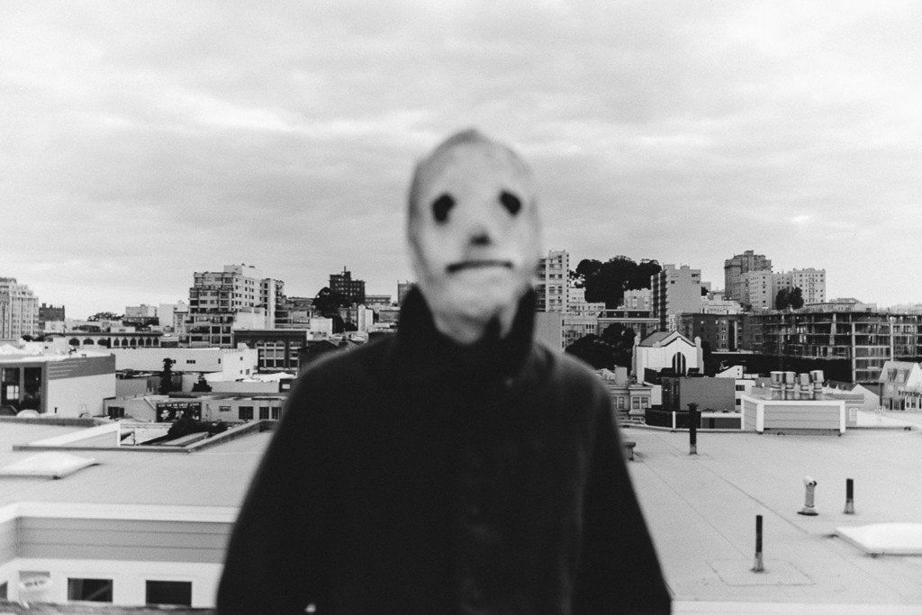Shaun Roberts photo of figure with mask on rooftop