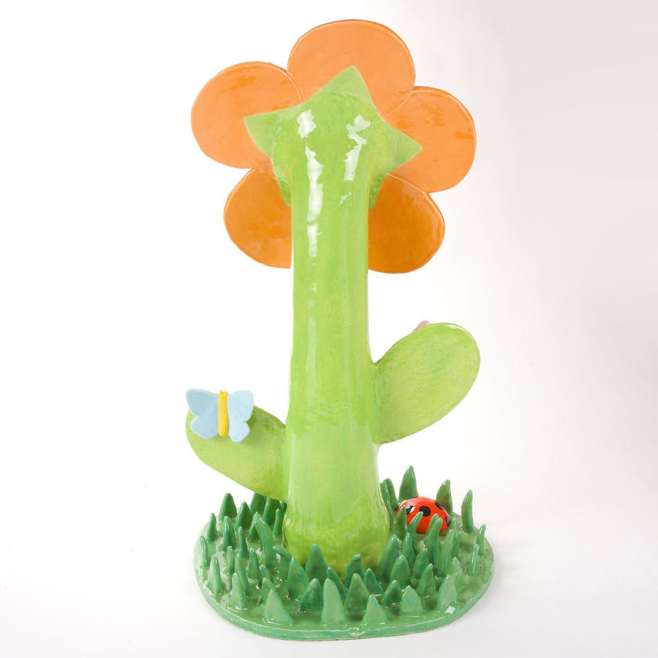 Lorien Stern's ceramic sculpture of an orange flower with grass and bugs