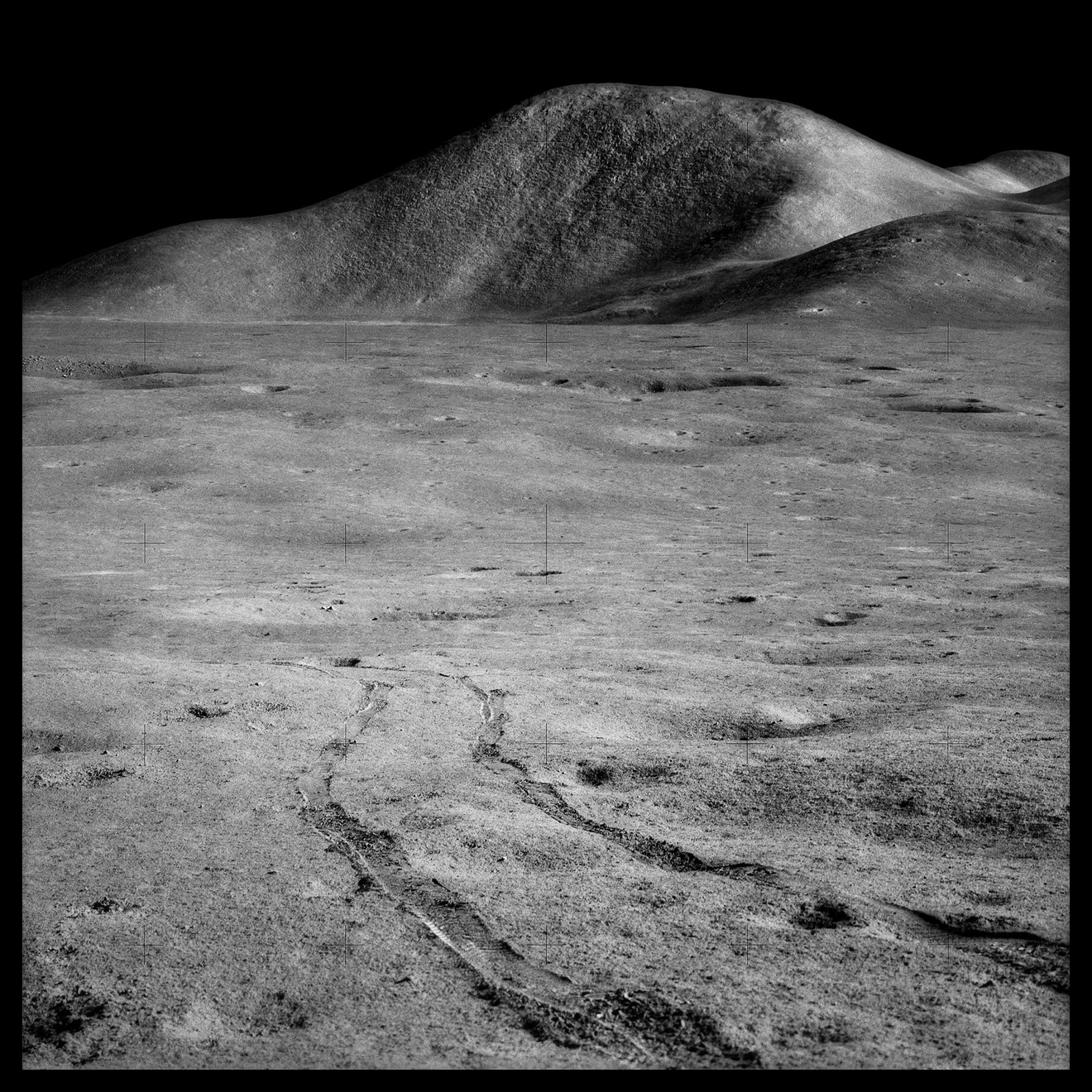 Rover Tracks and Mount Hadley Rising 15,000 Feet Over the Marsh of Decay;, Photographed by James Irwin, Apollo 15, July 26-August 7, 1971
