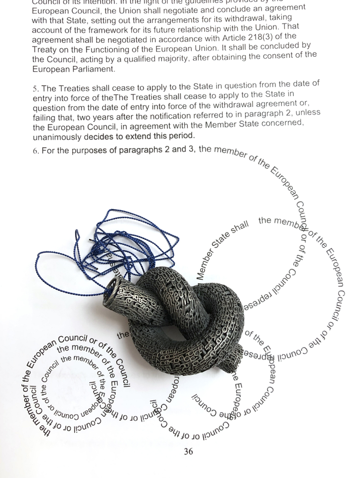 Jonathan Boyd  Untying the Mess, 2019  Pendant  Silver, silk and an altered copy of the Lisbon Treaty  30 x 20 x 6 cm