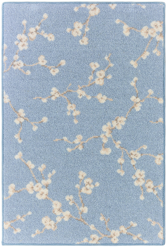 1'6" x 2'3" asuka sample in the sky colorway. the design features small cherry blossoms against a bright blue background