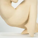 Figurative sculpture in white clay by artist Emilio DiIorio. Crouching figure is No. 2 in artist's Fragmented Aphrodite series.