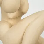 Figurative sculpture in white clay by artist Emilio DiIorio. Crouching figure is No. 2 in artist's Fragmented Aphrodite series.