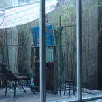 View of the open-air barber shop from inside of a house