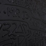 Detail photo of “Johnny Cash”, painting by Cayla Birk artist from South Florida. Available at Carousel Fine Art Miami. The artist’s technique blends acrylic, spray paint and silicone on canvas, creating a distinct mixed media style. Birk's work is marked by intricate designs and recognizable gestures, combining contemporary culture, history, music, and literature. Her art challenges conventional thinking, offering new and unexpected experiences. Colors of this work : White, Black